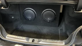 a car audio subwoofer installed in a trunk