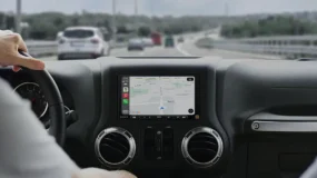 The inside of a car with a GPS system showing on the car radio screen