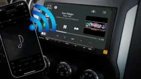 A car stereo system and cellphone with wi-fi bars connecting them