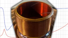 A coil of copper wire with a graph behind it