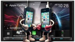 Two phones with arms and legs, each with boxing gloves on, facing off in front of a kenwood car audio screen